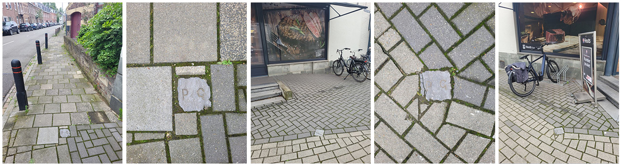 Grensstenen bij slagerij Heuts in het trottoir. Duidelijk te zien is het verschil in kleur tussen de betonklinkers. De donkere klinkers liggen op het perceel van de winkel, de lichtere zijn openbaar gebied